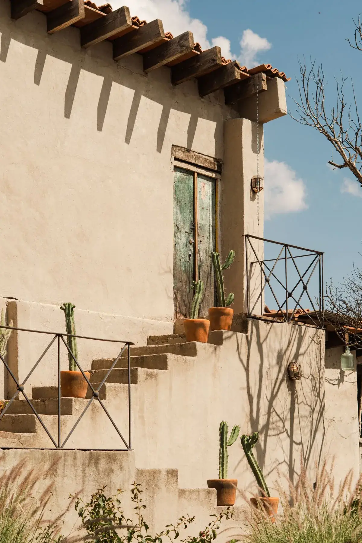 Rustic stucco building with cacti showing natural weathered color in Tucson AZ