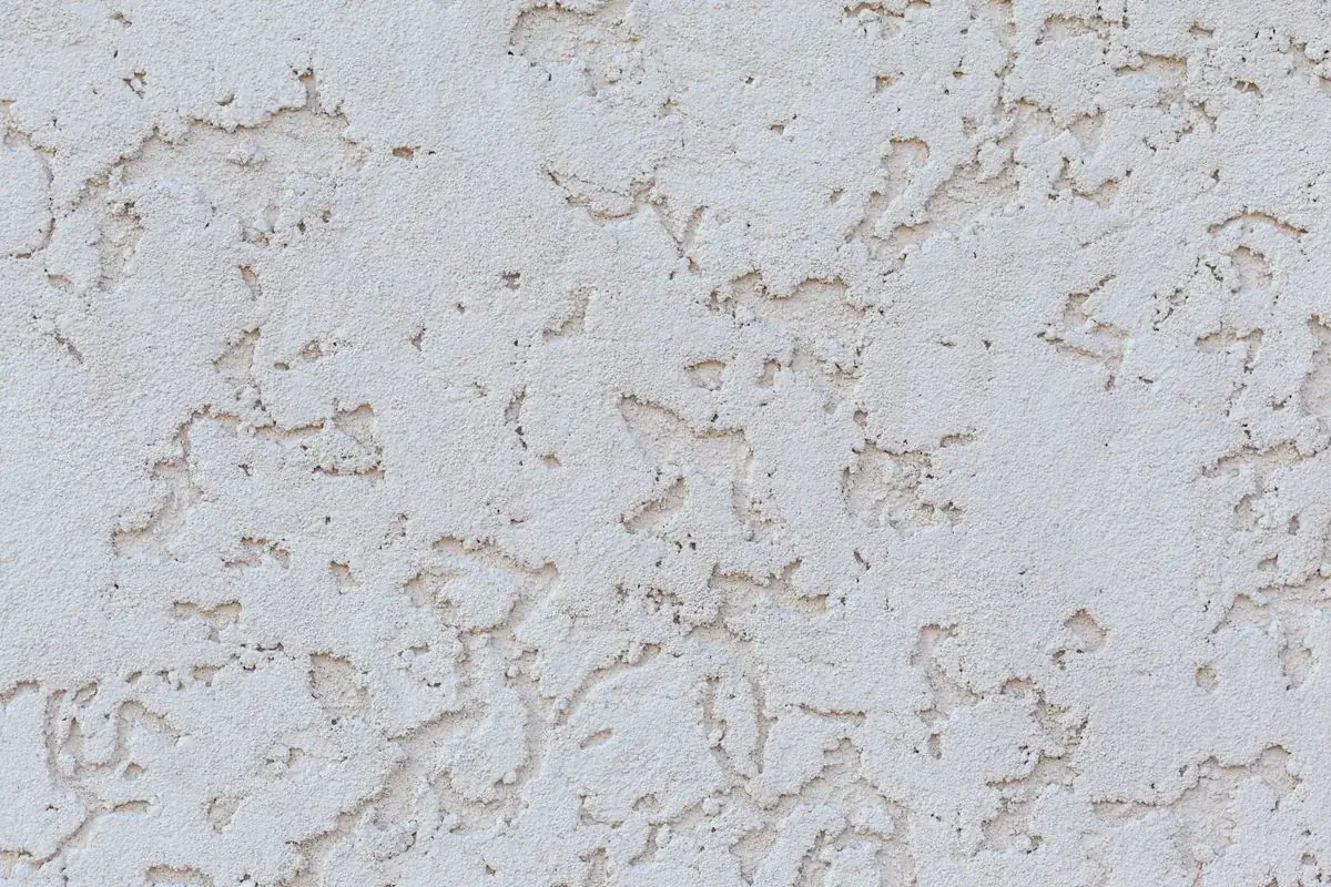 White skip-trowel stucco texture showing the hand-applied finish pattern